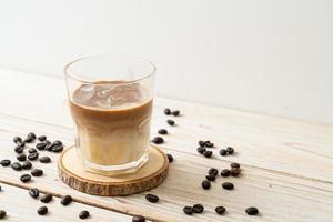 Dirty coffee, cold milk topped with hot espresso coffee shot photo