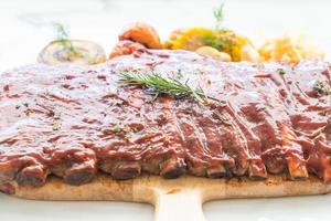 Grilled rib pork with barbecue sauce and vegetable photo