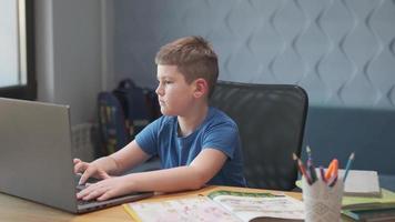 retrato de un niño enseñando lecciones en línea a distancia usando una computadora portátil e internet a través de un chat de video. aprendizaje a distancia en casa. foto