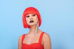 Portrait of beautiful sexy woman in red wig Bob hairstyle. Long earring