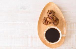 Black coffee with cookies on wood photo