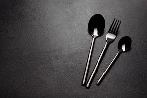 Set of tableware ready for the meal with black copy space photo