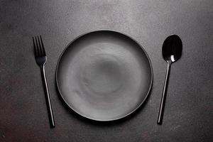 Set of tableware ready for the meal with black copy space photo