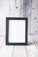 empty frame on wooden background . photo