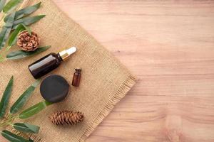 eucalyptus essential oils in a glass bottle with green leaf on table photo