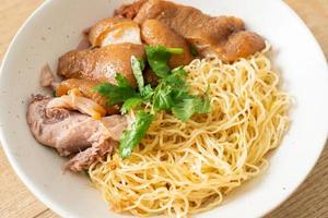 Dried stewed pork leg noodles bowl - Asian food style photo