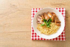 Dried stewed pork leg noodles bowl - Asian food style photo