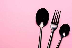 Metal Spoon and fork Isolated on pink background photo