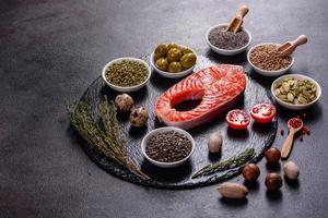 Raw trout red fish steak served with herbs and lemon photo