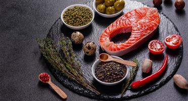Raw trout red fish steak served with herbs and lemon photo