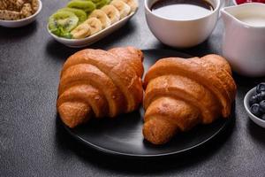 Delicious breakfast with fresh croissants and ripe berries photo