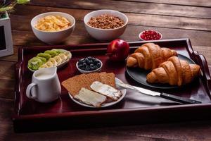 Delicious breakfast with fresh croissants and ripe berries photo