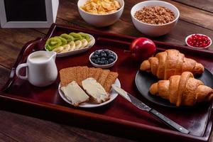 Delicious breakfast with fresh croissants and ripe berries photo