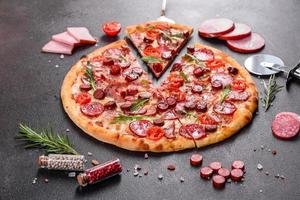 Pepperoni Pizza with Mozzarella cheese, salami and ham photo