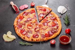 Pepperoni Pizza with Mozzarella cheese, salami, ham photo