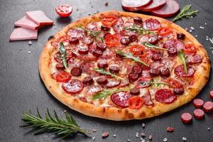 Pepperoni Pizza with Mozzarella cheese, salami and ham photo