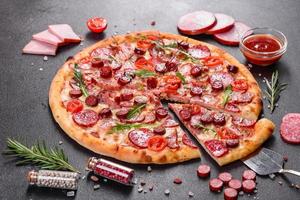 Pepperoni Pizza with Mozzarella cheese, salami and ham photo