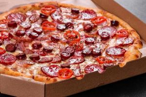 Pepperoni Pizza with Mozzarella cheese, salami and ham photo