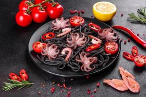 Black seafood pasta with shrimp, octopus and mussels photo