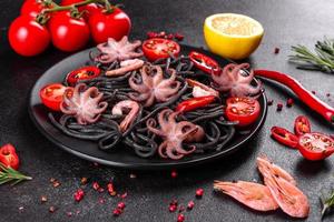 Black seafood pasta with shrimp, octopus and mussels photo