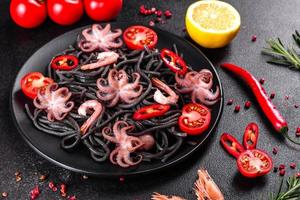 Black seafood pasta with shrimp, octopus and mussels photo