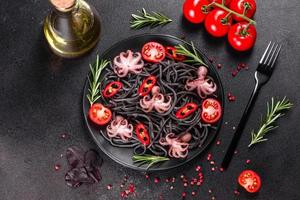 Black seafood pasta with shrimp, octopus and mussels photo