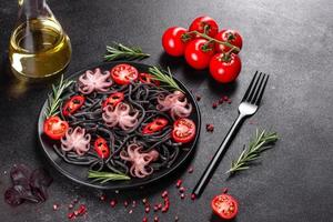 Black seafood pasta with shrimp, octopus and mussels photo