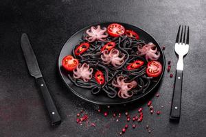 Black seafood pasta with shrimp, octopus and mussels photo