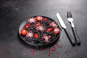 Black seafood pasta with shrimp, octopus and mussels photo