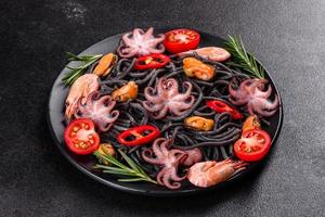 Black seafood pasta with shrimp, octopus and mussels photo