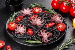 Black seafood pasta with shrimp, octopus and mussels photo