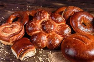 Composition of fresh baked sweet buns with poppy and jam photo