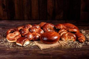 Composition of fresh baked sweet buns with poppy and jam photo