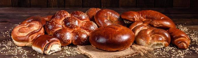 Composition of fresh baked sweet buns with poppy and jam photo