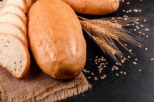 Fresh baked white bread on a brown concrete background photo