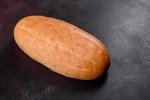 Fresh baked white bread on a brown concrete background photo