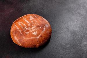 Fresh baked brown bread with coat of arms of Ukraine photo