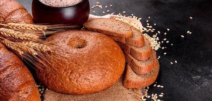 Fresh baked brown bread on a brown concrete background photo