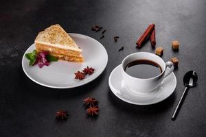 Fresh delicious carrot cake with cream on a dark background photo