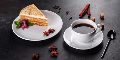 Fresh delicious carrot cake with cream on a dark background photo