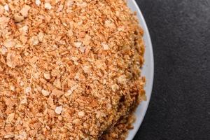 Fresh delicious cake napoleon with cream on a dark background photo