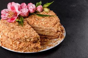 Fresh delicious cake napoleon with cream on a dark background photo