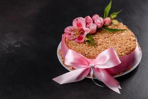 Fresh delicious cake napoleon with cream on a dark background photo