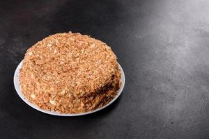 Fresh delicious cake napoleon with cream on a dark background photo