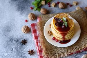 Delicious fresh beautiful pancakes with citrus honey and jam photo