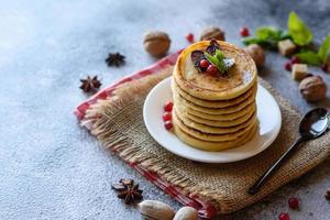 Delicious fresh beautiful pancakes with citrus honey and jam photo