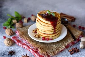 Delicious fresh beautiful pancakes with citrus honey and jam photo