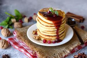 Delicious fresh beautiful pancakes with citrus honey and jam
