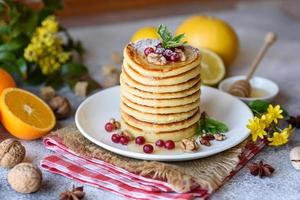 Delicious fresh beautiful pancakes with citrus honey and jam photo