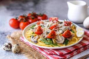 Spaghetti with mushrooms, cheese, spinach, rukkola and cherry tomatoes photo